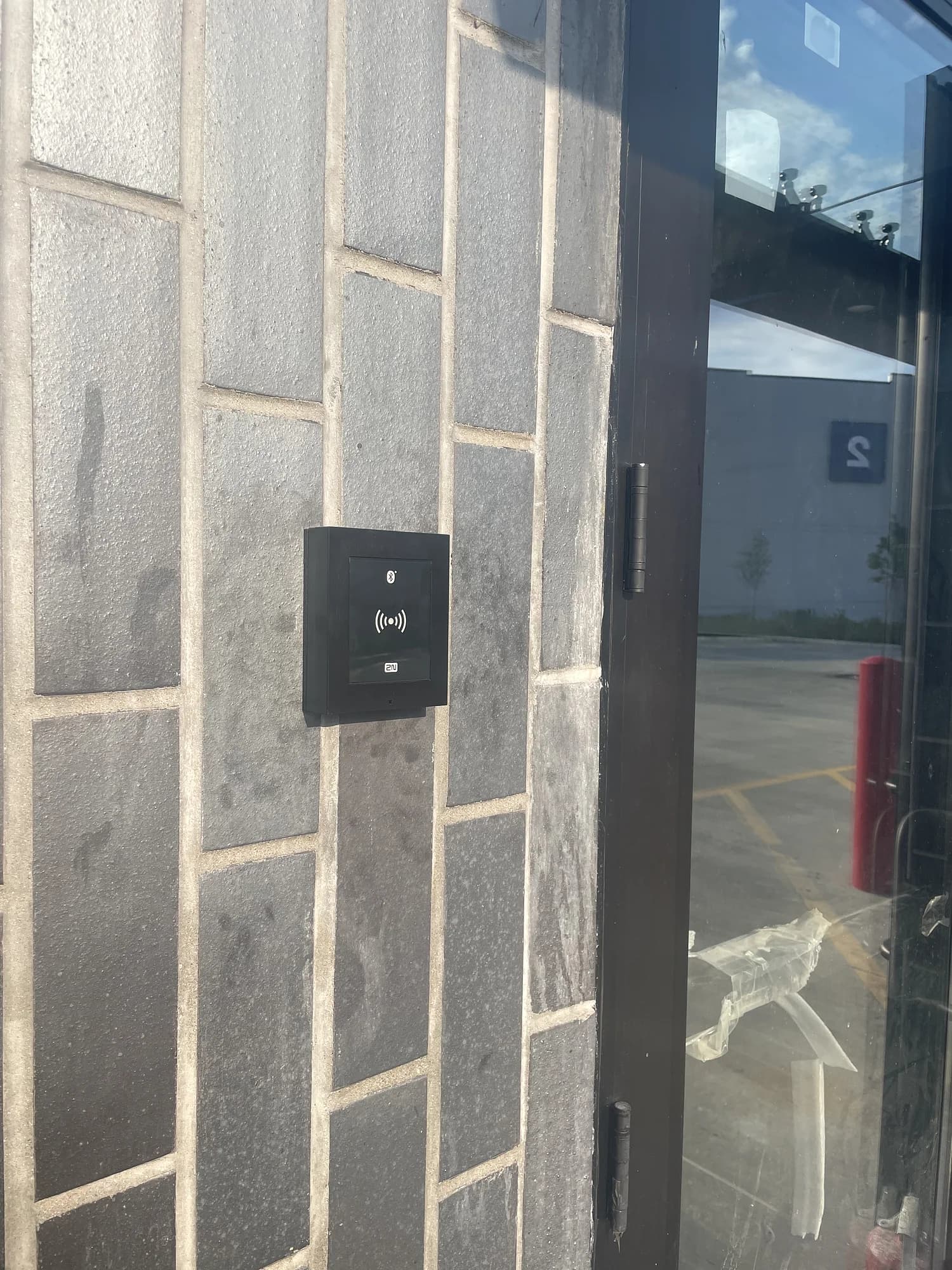 Contactless building access reader installed by YCOP at a commercial doorway