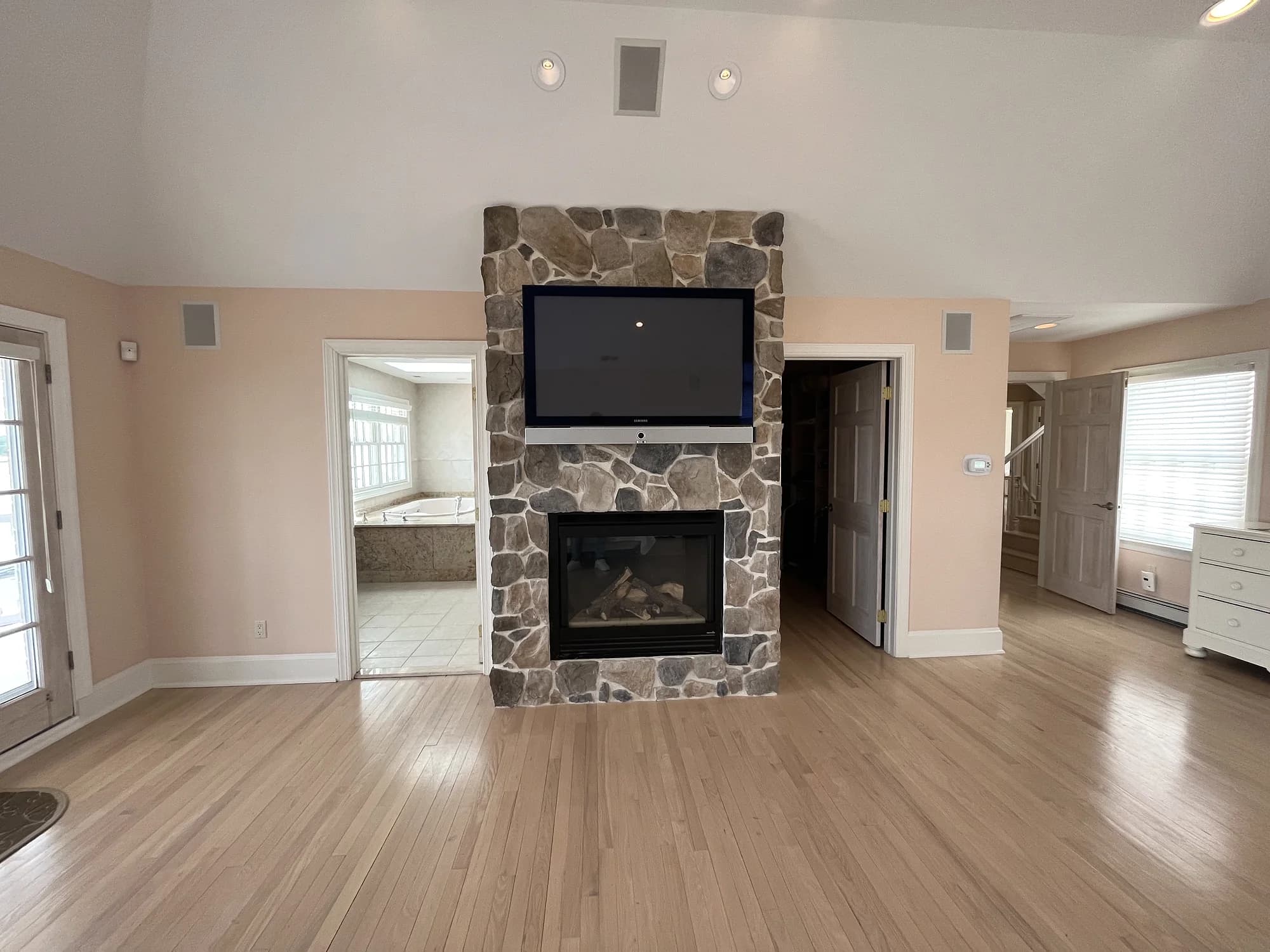 Wall-mounted television integrated above a fireplace in a residential living room
